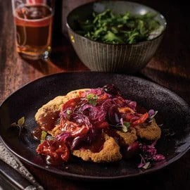 Lamb Cutlet Schnitzel With Grilled Tomatoes Olives, and Onion Jam Gravy